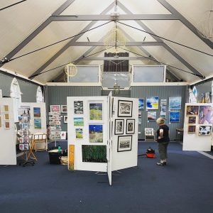 Art displays inside the Tin Tabernacle during the hART 2023 exhibition in Hythe, Kent.
