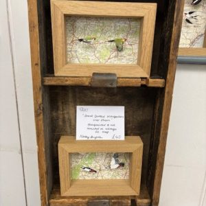 Framed mixed-media artworks featuring birds and vintage maps at the 2025 hART Exhibition in Hythe, Kent.