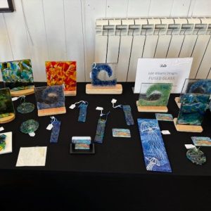 Handmade fused glass artworks and decorative pieces displayed at the 2025 hART Exhibition in Hythe, Kent.