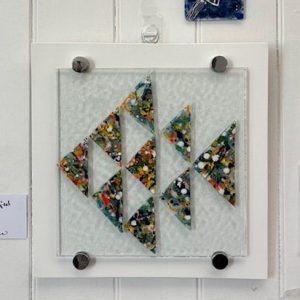 Contemporary fused glass artwork featuring colourful geometric shapes at the 2025 hART Exhibition in Hythe.