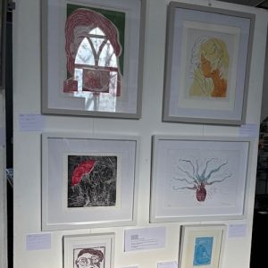 Framed figurative and illustrative artworks displayed at the 2025 hART Exhibition in Hythe, Kent.