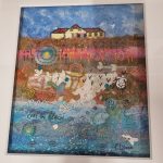 Coastal textile artwork by Carol Dixon featuring a seaside building, beach and layers of colourful stitched fabrics