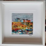 Beach hut textile artwork by Carol Dixon featuring colourful huts and a richly textured shoreline