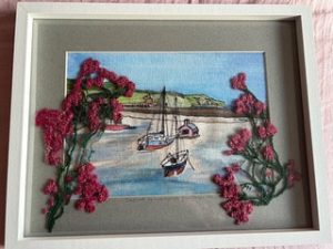 Mixed-media textile artwork by Marie-Hélène Hunter featuring boats in a harbour framed by richly textured embroidered flowers.