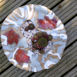 Ceramic garden planter by Mary Sampson decorated with autumn leaves and planted succulents