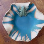 Blue glazed ceramic dish by Mary Sampson featuring a sculpted frog