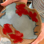 Handmade ceramic dish by Mary Sampson decorated with vivid red autumn leaves