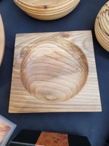 Square woodturned bowl by Paul Johnson with a deep circular centre displaying the natural grain and character of the timber.