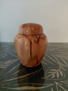 Hand-turned wooden lidded vessel by Paul Johnson showcasing warm natural colouring, distinctive grain and a polished finish.