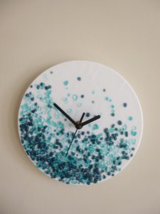 Blue and turquoise fused glass wall clock by Roger Sturley, HART guest artist in Hythe.