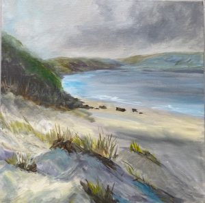 Coastal landscape painting by Sue Houghton showing a quiet sandy beach, grassy dunes and blue water beneath a dramatic grey sky.
