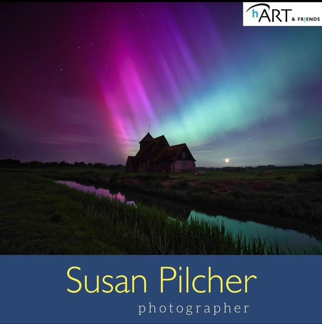 Night photography by Susan Pilcher showing a church beneath colourful northern lights